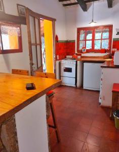 a kitchen with a wooden counter top in a room at Cabañas spa el petrel in San Javier +12 photos