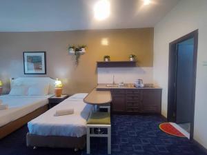 a hotel room with two beds and a sink at Rainbow Paradise Resort by Achlys Collection in Tanjung Bungah +16 photos