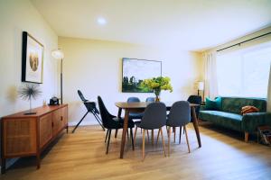 a living room with a table and chairs and a couch at Spacious San Jose Lux 3BR: Prime Location in San Jose