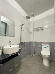 een badkamer met een douche, een toilet en een wastafel bij Minh Phương Hotel - Khách sạn Thủ Dầu Một Bình Dương in Xóm Ông Phùng