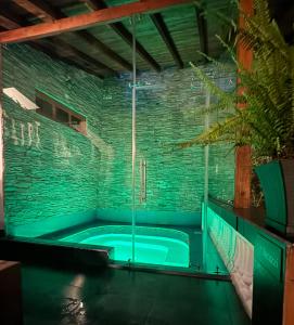 a hot tub in a room with a brick wall at Vista del Angel Hotel Boutique in Quito