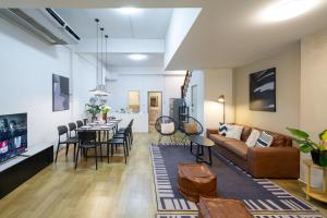 a living room with a couch and a table at SONGPEEP HOUSE in Ban Zong Katiam