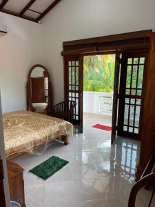 - une chambre avec un lit et une porte ouverte dans l'établissement Slater Villa, à Beruwala