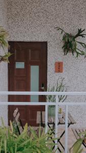 a front door of a building with a plant at 富士A’tolan in Fushan
