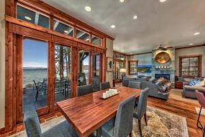 a living room with a wooden table and a couch at The PEAK Tallac 15 - The Ultimate in Lakefront Luxury in South Lake Tahoe