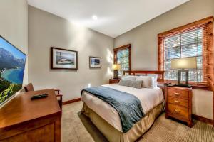 a bedroom with a bed and a desk and a window at The PEAK Tallac 15 - The Ultimate in Lakefront Luxury in South Lake Tahoe +47 photos