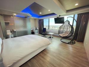 um quarto com uma cama grande e um baloiço em 幸福星空親子精品旅館 em Luodong