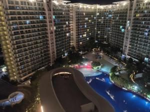 an aerial view of a pool in the middle of a building at The Bahamas & Maldives Suites at Azure Residences near Manila Airport in Manila