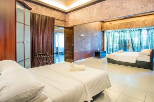 a hotel room with two beds and a balcony at Zoo Villa by Cobnb at Zoo Negara, Ampang Area in Ampang