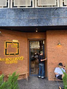 a man standing in the door of a kitchenling house at Khunluang Hostel in Chiang Mai