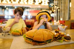 two women sitting at a table eating sandwiches at Nickelodeon Hotels & Resorts Punta Cana - Gourmet All Inclusive by Karisma in Punta Cana
