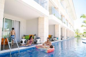 a group of people in the swimming pool at a hotel at Nickelodeon Hotels & Resorts Punta Cana - Gourmet All Inclusive by Karisma in Punta Cana