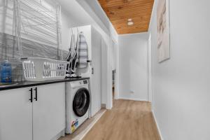 a laundry room with a washer and dryer at Recharge in Waurn Ponds in Geelong