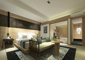 a hotel room with a bed and a chair at Rama Beach Resort and Villas in Kuta