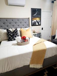 a large white bed with a basket of flowers on it at Beautiful All Private GuestSuite in Lancaster