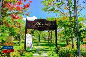 a sign in the middle of a park with trees at TTC Van Phong Bay Resort - Himalaya Sauna & Steam Retreat Included in Ninh Hòa