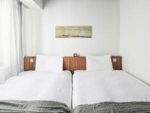 Postel nebo postele na pokoji v ubytování VESSEL INN NAMBA