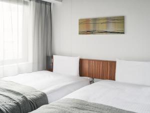 Postel nebo postele na pokoji v ubytování VESSEL INN NAMBA