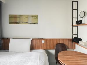 Postel nebo postele na pokoji v ubytování VESSEL INN NAMBA