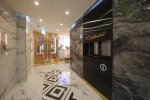 a lobby with a hotel sign on the wall at Calton Hill Hotel in Jeonju