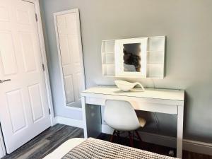a white desk with a white chair in a bedroom at Plymouth city centre apartment near Theatre Royal in Plymouth
