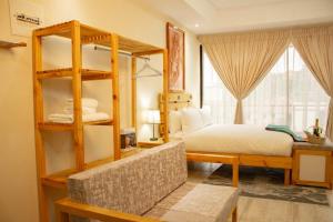 a bedroom with a bed and a large window at Thabeng Hotel & Restaurant in Maseru