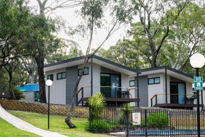 a house with a fence in front of it at Belair National Park Holiday Park in Belair