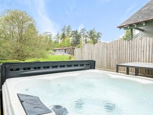 d'un bain à remous dans une arrière-cour avec une clôture en bois. dans l'établissement Hazel - Woodland Cottages, à Bowness-on-Windermere