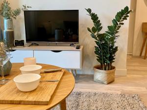 a living room with a table and a tv at YORK 1903 Self Catering in Sydney