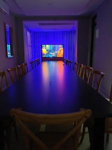 une salle à manger avec une grande table et une télévision dans l'établissement Thabeng Hotel & Restaurant, à Maseru