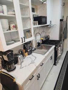a kitchen with white cabinets and a counter top at Luxurious All Private GuestSuite in Lancaster