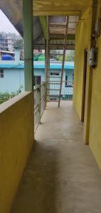 an empty hallway of a building with a view of the water at Mabie Homestay in Kohīma