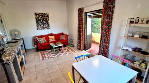 a living room with a red couch and a table at Colourful BnB in The Crags