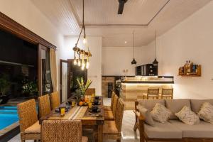 una sala de estar con una mesa y un sofá en Comfy 3bd Family Villa with Private Pool in Central Location, en Kerobokan
