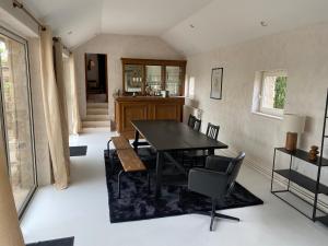 a dining room with a black table and chairs at Gite Authentique Évasion in Saint-Mard-de-Vaux +22 photos
