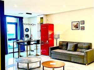 a living room with a couch and a table at Calton Hill Hotel in Jeonju