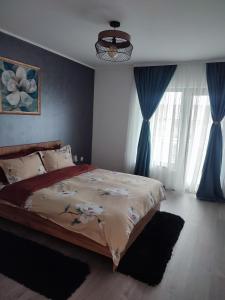 Un dormitorio con una cama grande con cortinas azules. en IONE & B Residance, en Sibiu 28 fotos más