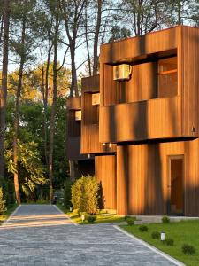 a wooden building with a walkway in front of it at Buxus Villas Shekvetili in Shekvetili