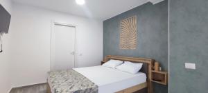 a bedroom with a bed and a painting on the wall at Olimp Family - Olimp Sea View Apartments in Olimp