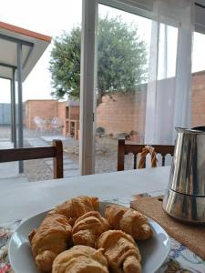 a plate of croissants sitting on a table at L'ocell del Pla in Ivars d'Urgell