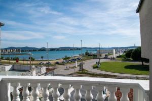 a balcony of a building with a view of the water at Guest House Maritimo in Sukošan