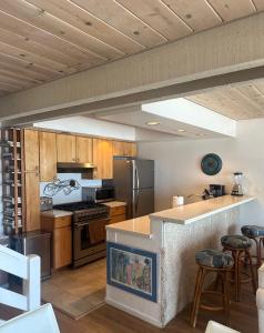 a kitchen with stainless steel appliances and wooden cabinets at Ocean Front Getaway in La Selva Beach in La Selva Beach