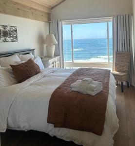 a bedroom with a bed with a view of the ocean at Ocean Front Getaway in La Selva Beach in La Selva Beach