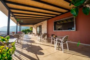 a patio with tables and chairs on a building at Yoga House Kaş in Kaş