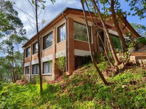 a house on top of a hill with trees at Relais De Mantadia in Andasibe