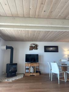 a living room with a fireplace and a table and chairs at La Selva Beach Ocean Front Townhome - Direct Beach & Ocean Access in La Selva Beach