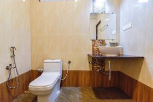 a bathroom with a toilet and a sink at FabHotel Sterling Garden in Old Goa