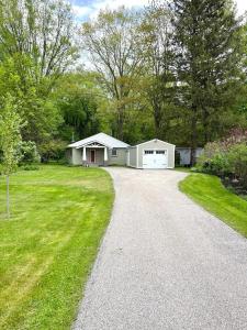 a house with a garage and a driveway at 4358 W, Lake Road home in Mayville