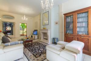 a living room with two white couches and a fireplace at Well Located Townhouse & Courtyard Kalka - Happy Rentals in Kalkara +25 photos