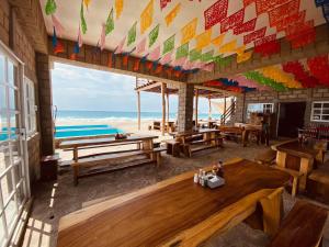 ein Restaurant mit Tischen und Strandblick in der Unterkunft Sal Marina Restaurante y Cabañas in Salina Cruz